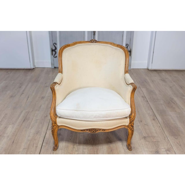 This 20th-century French bergère is an elegant representation of the Louis XV style, known for its graceful curves and...