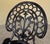 Ornate three-piece garden bistro set comprising two chairs and a round table. The design recalls late-Victorian garden...