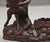 A lovely ornate 19th Century black forest carving of a fox, sitting cross legged reading a book, the fox wearing a jacket...
