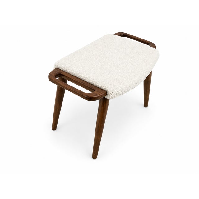 Mid century style modern solid walnut stool. Upholstered in a white Boucle. The stool made in the manner of Hans J. Wegner...