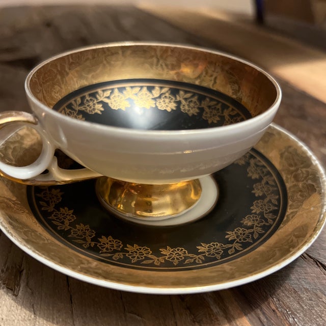 Fine Bone China Demitasse Cup & Saucer - features a gold band on both the saucer and cup and the handle trimmed in gold...