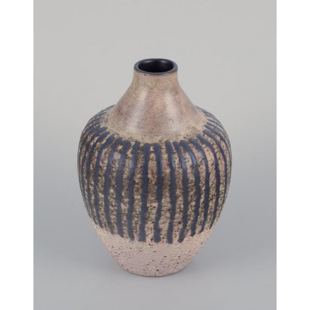 Mari Simmulson (1911-2000) for Upsala Ekeby, Sweden. Ceramic vase in a modernist style. Decorated with dark blue stripes...