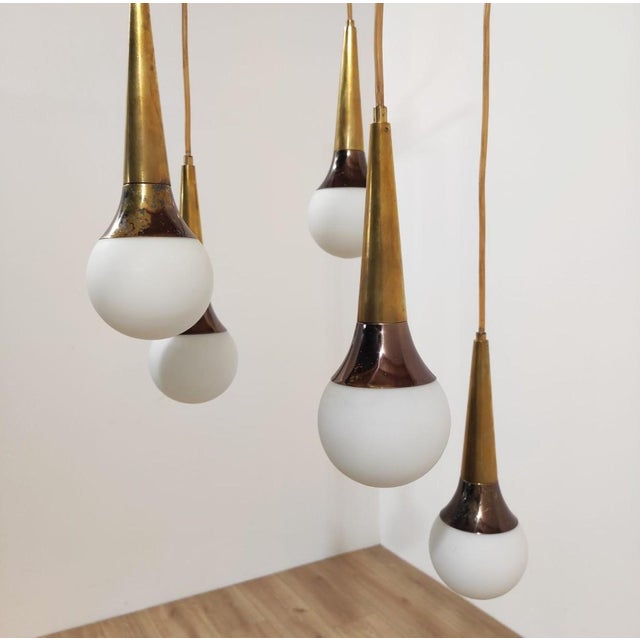 Five-light pendant lamp produced by Stilnovo, featuring a black-painted brass structure with five arms, from which cables...