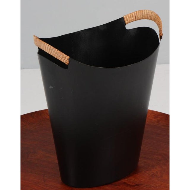 Finn Juhl & Grethe Kornerup-Bang paper bin in lacquered steel. Handles with cane. This piece is attributed to the...
