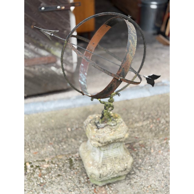 Sandstone/metal/copper. Baluster-shaped base with leaf-inspired decoration. with a large sundial made of curved bars. H....