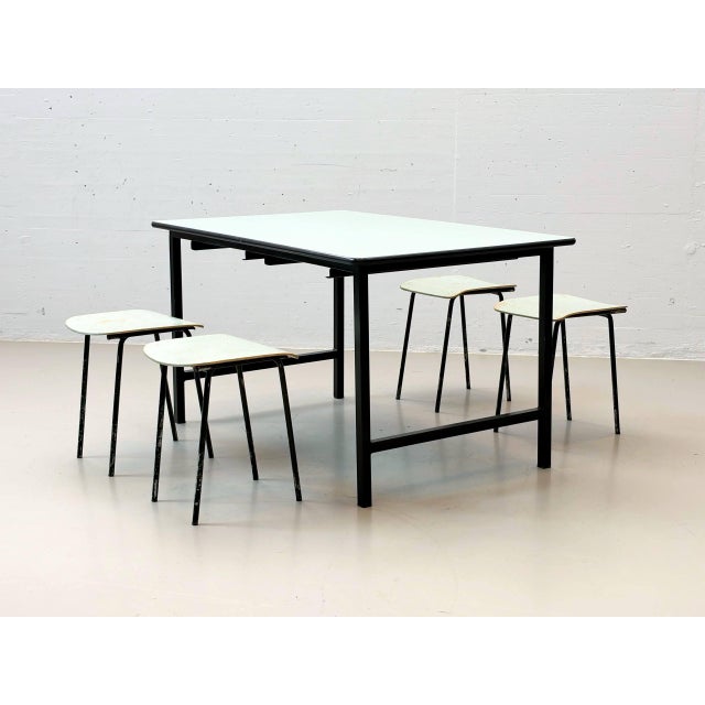Charming vintage set consisting of a rectangular work table with a greenish-blue formica tabletop and four matching stools...