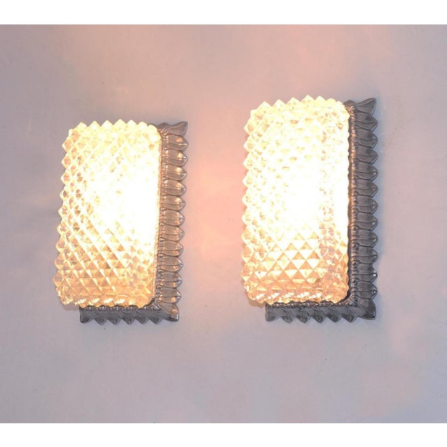 Elegant pair of wall sconces made of crystal glass on a silver frame. Manufactured by Glashutte Limburg, Germany in the...