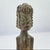 This carved wooden figure is attributed to the Tiv people of Nigeria. Standing in an upright, frontal pose with hands held...