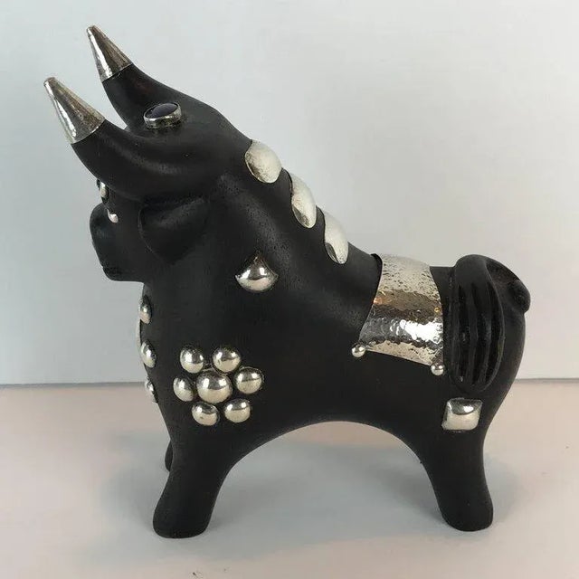Midcentury carved wood and silver Taurus bull sculpture, well carved with expressive face and glass eyes. The body with...
