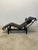 Dark Brown leather LC4 Noire chaise lounge with Black leather bolster pillow on black tubular steel and black steel base...