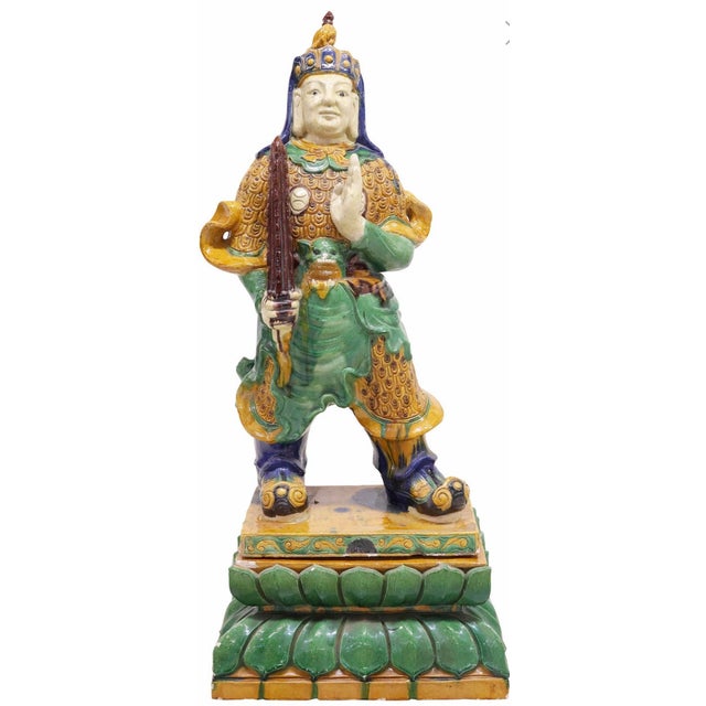 A rare and most impressive antique Chinese pottery figure, modeled as a powerful Ming Dynasty style warrior, standing...