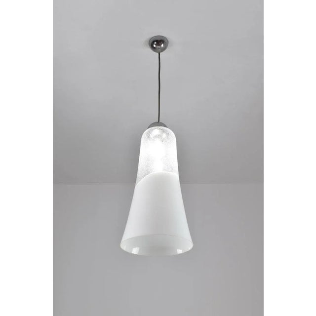 Italian Murano glass pendant light by Mazzega, dating to the 1970s and retaining its maker label. The shade is made in...
