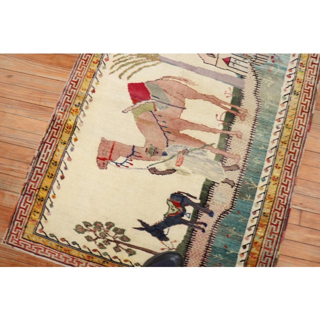 Mid 20th century Turkish Anatolian rug with a pictorial design depicting a donkey and camel. Size: 3'2'' x 3'11''.