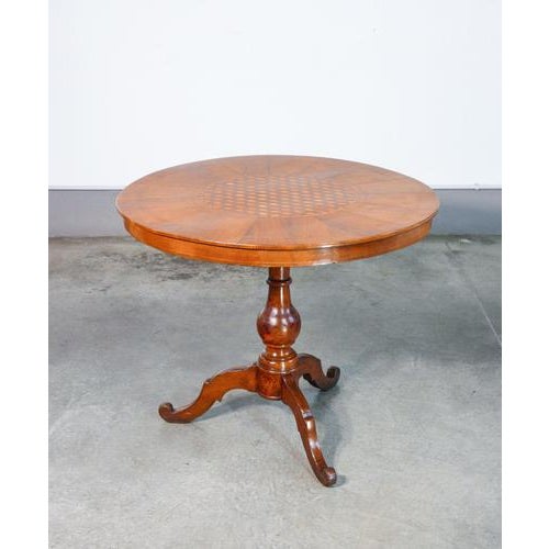 Round coffee table by rolo in veneered and inlaid wood, central leg ending in a tripod origin italy period 19th century...