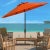 Conjure images of dining al fresco at a romantic café on the Riviera with this orange Ortega Umbrella. Keep cool on your...