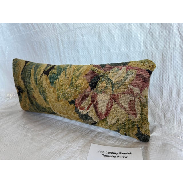 This decorative pillow is crafted from an authentic 17th century Flemish tapestry fragment, offering a rich blend of...