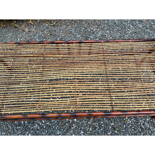 A very unique bench constructed of iron that is finished in tortoise shell. The seat is comprised of bamboo and iron and...