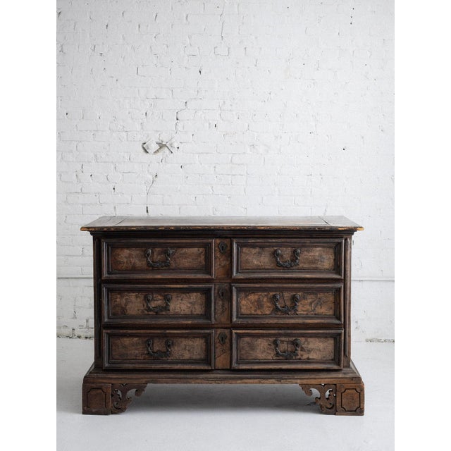 17th century Emlilian chest of three drawers. Antique patina showing darkened wood and iron hardware. Drawer pulls depict...