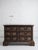 17th century Emlilian chest of three drawers. Antique patina showing darkened wood and iron hardware. Drawer pulls depict...