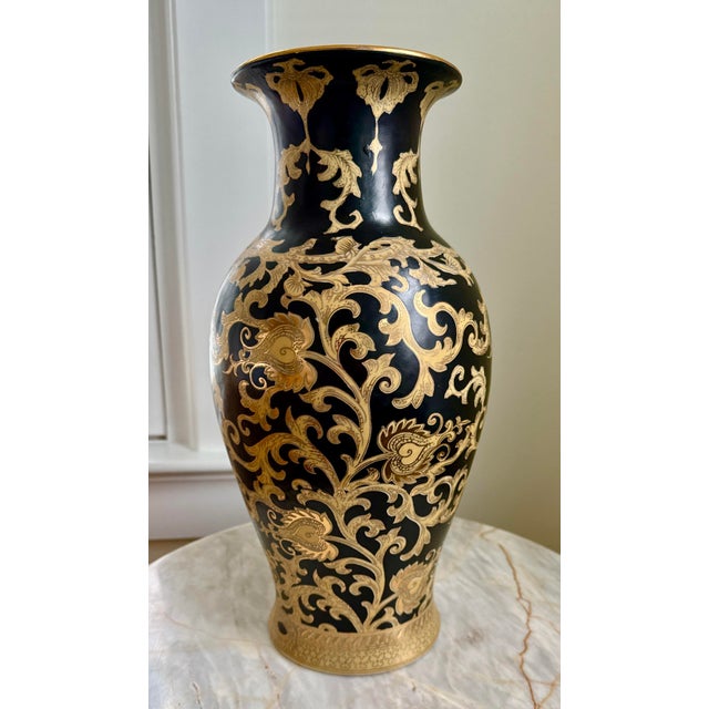Gorgeous vintage Chinese vase showcasing a gold vine and leaf design against a dramatic black background. Unique and...
