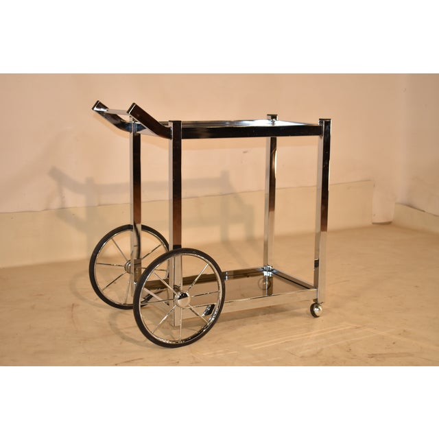 A well-built Mid Century Modern two tier, smoked glass, chrome bar cart, with exceptional high quality thick chrome work...