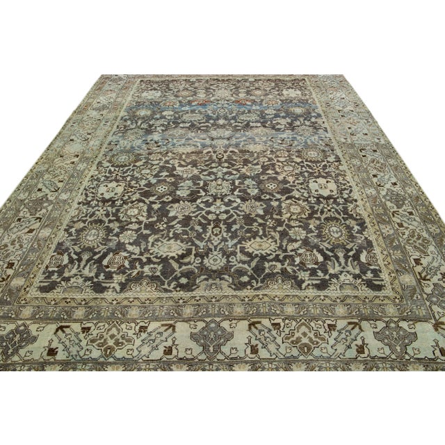 Beautiful Antique Malayer hand-knotted wool rug with a brown field. This Malayer rug has a beige frame and blue accents in...