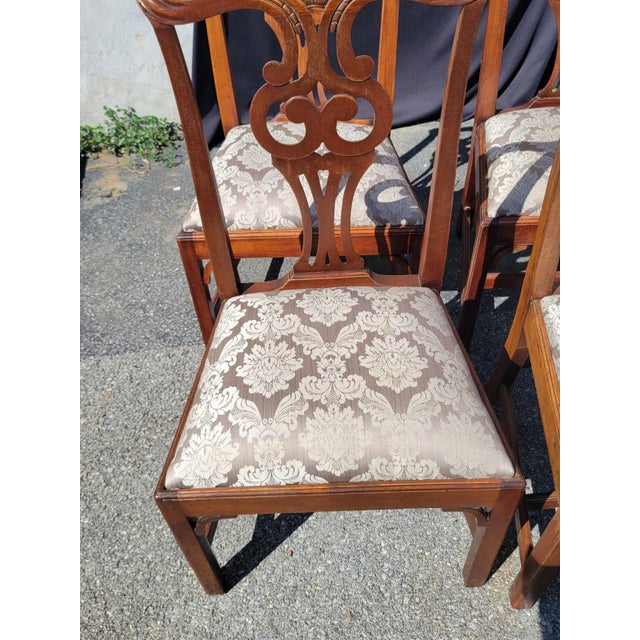 This product is a set of four antique English dining room chairs, made of wood in a brown color. These post-1950 chairs...