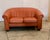 This funky orange leather loveseat sofa. Is perfect for the place , that loves color . Purchased in Copenhagen this piece...