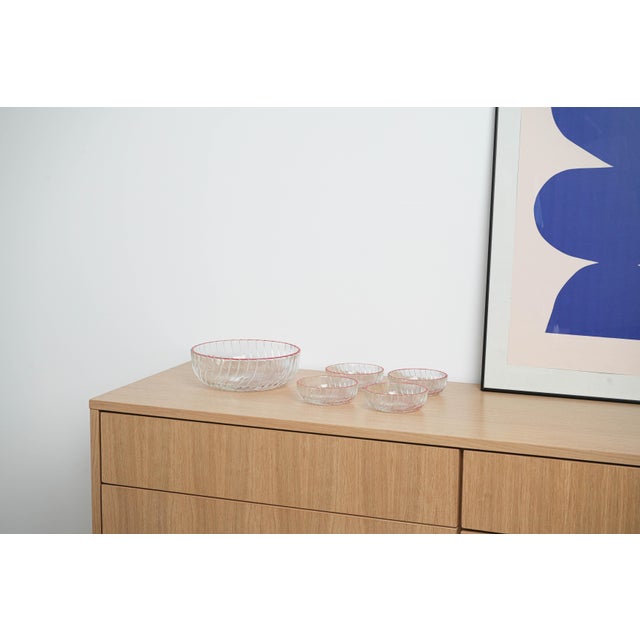 The salad bowl set was made in the 1970s in Italy. A set of five pressed glass salad bowls, including one larger and four...