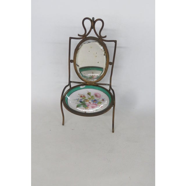 This beautiful Pocket Watch / Trinket Holder is made of brass, mirrored glass, and porcelain. The chair frame is brass and...