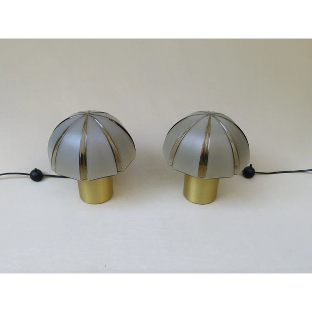 A pair of small table lamps, mushroom lamps, from the 70s by Peill & Putzler with bases of gold-coloured anodised...