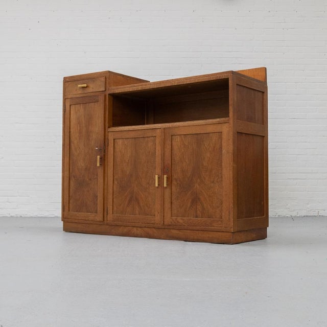 Dutch Art Deco cabinet, likely in the Hague School style, circa 1925–1930. The piece features a clear geometric design...