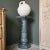 This refined marble pedestal, rendered in a striking deep green hue, is a versatile and timeless piece that enhances the...