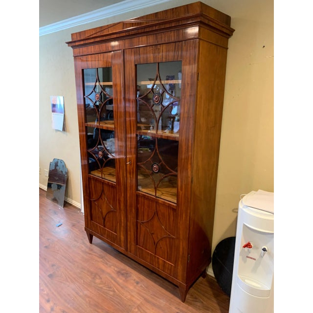 Exceptional 19th century Austrian Biedermeier flame mahogany neoclassical style bookcase. The cabinet has 3 adjustable...