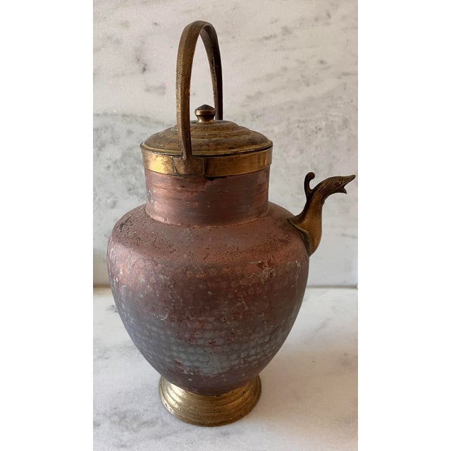 Large antique copper lidded hot water kettle with a top handle, figural spout, light hammered texture on the body and...