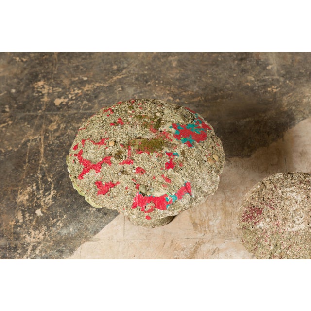 A set of three American Midcentury painted concrete mushroom garden ornaments with traces of red, turquoise and yellow...