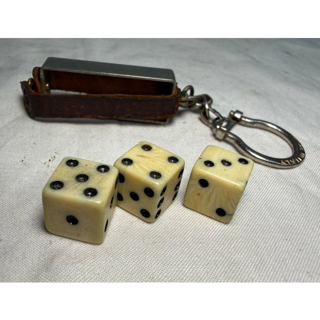 The antique travel dice holder keychain is a unique and vintage accessory for gambling collectors. Made in the United...