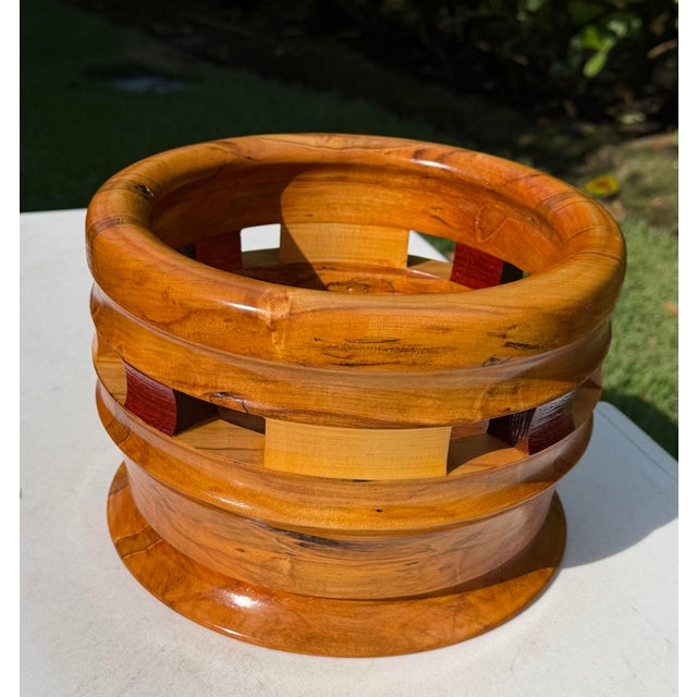 Handcrafted monkeypod wood bowl by Hugh James MacDonald Jr., featuring a substantial rounded form with an open geometric...