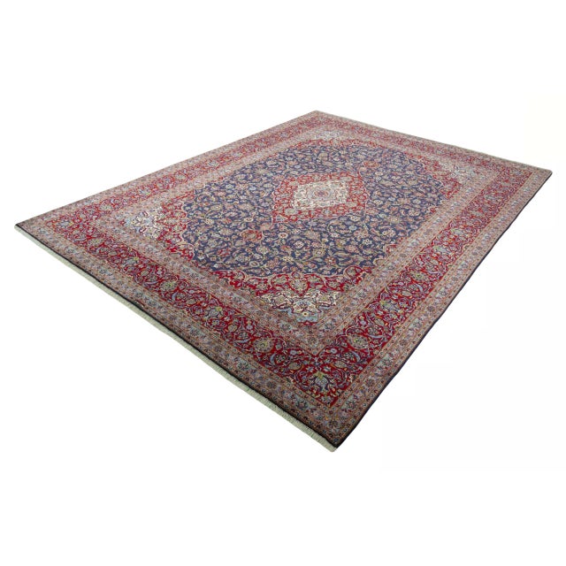 A magnificent hand-knotted Kashan that impresses with its deep, royal colors and masterfully composed floral ornaments. In...