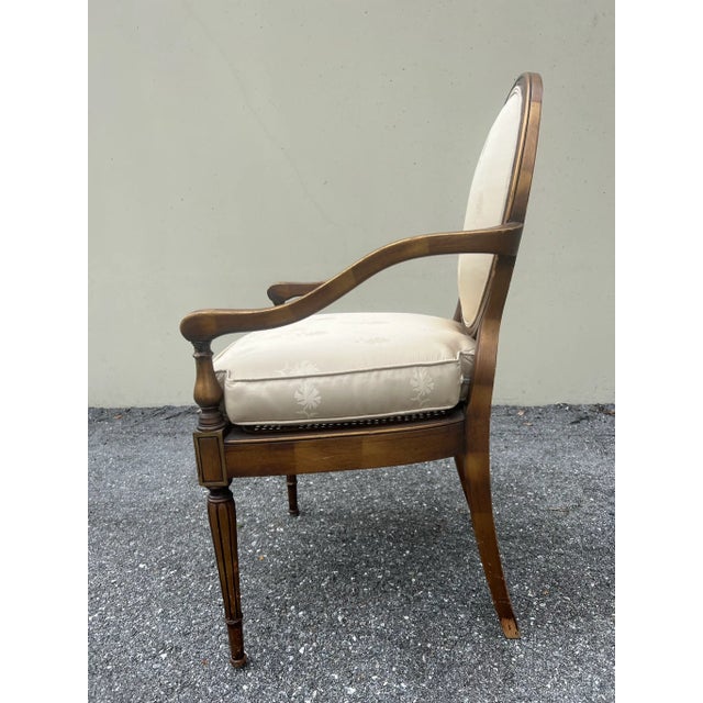 This Louis XVI style armchair has a walnut finish and white/cream upholstery. The cushion is able to come off for washing...