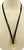 The product is an original 18k yellow gold pendant necklace with a suede cord. This fine jewelry piece exudes a stylish...