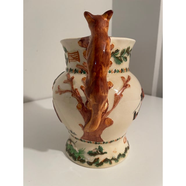 A richly detailed English sporting jug by Beswick, Staffordshire, celebrating the legendary huntsman John Peel. With its...