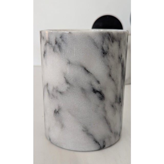 Channel the eclectic, unapologetic style of the Memphis design movement with this striking set of four marble canisters....