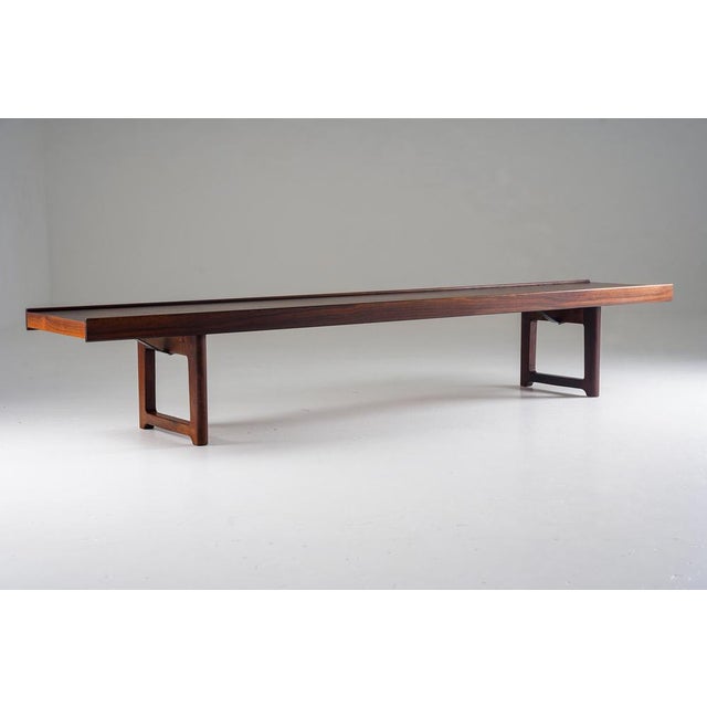 Iconic “Krobo” bench designed by Torbjørn Afdal, executed in richly grained rosewood. The design is architectural and...