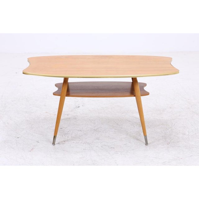 Vintage coffee table with an exceptionally organic tabletop shape and matching shelf. The gently curved lines, tapered...
