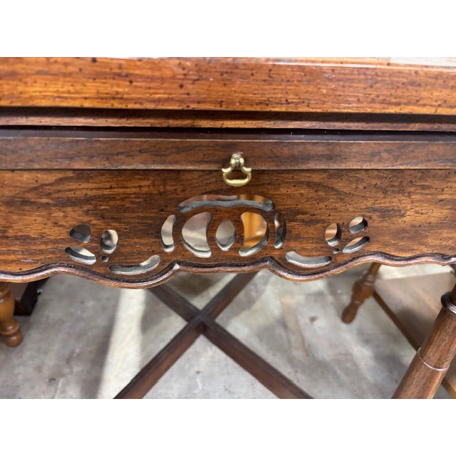 Gorgeous side table in the Chippendale style. Detailed basketweave top with a retractable shelf. In a rich walnut wood,...