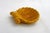 Scallop shell-shaped trinket dish with a striated design. Can be hung for wall decoration. Made of slip-cast earthenware...