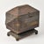 An incredible example of American folk art this large tramp art box features four round feet that the base pedestal sits...