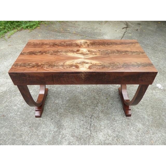 Desk in highly figured feather crotch walnut in an open minimalistic design. Superbly book matched patterns revealing the...