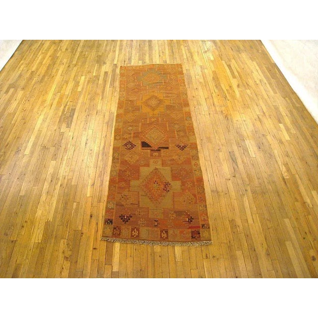 A consigned vintage Turkish Kilim oriental rug, in a runner size. Circa 1930, size 9'8" x 3'2". This hand-made rug is...